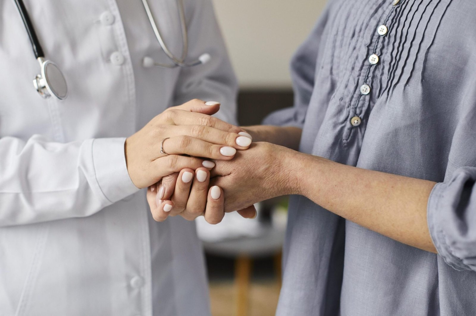 covid-recovery-center-female-doctor-holding-elder-patient-s-hands