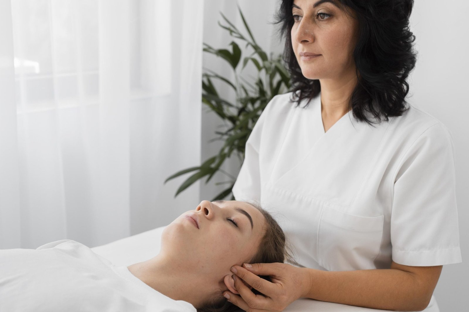 female-osteopathist-treating-patient-indoors
